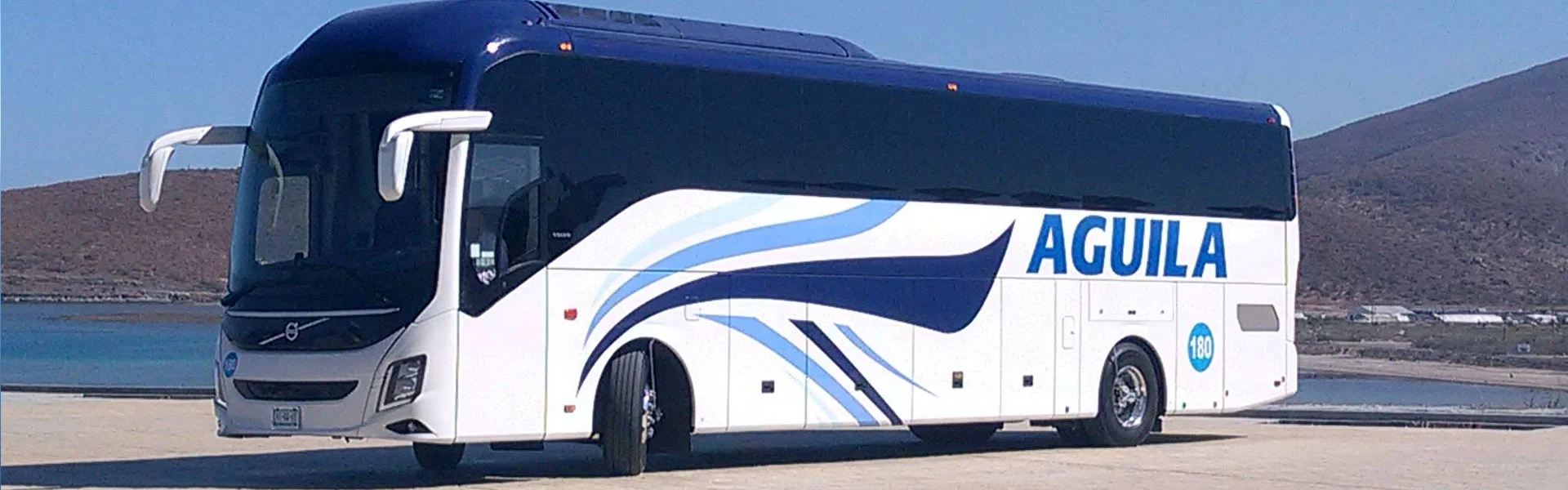 Autobuses Águila coach parked by the water