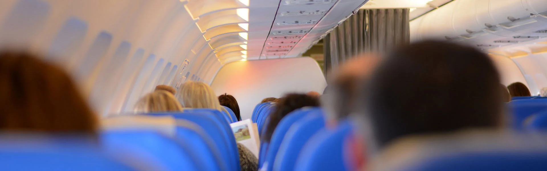 Passengers seated in an airplane cabin